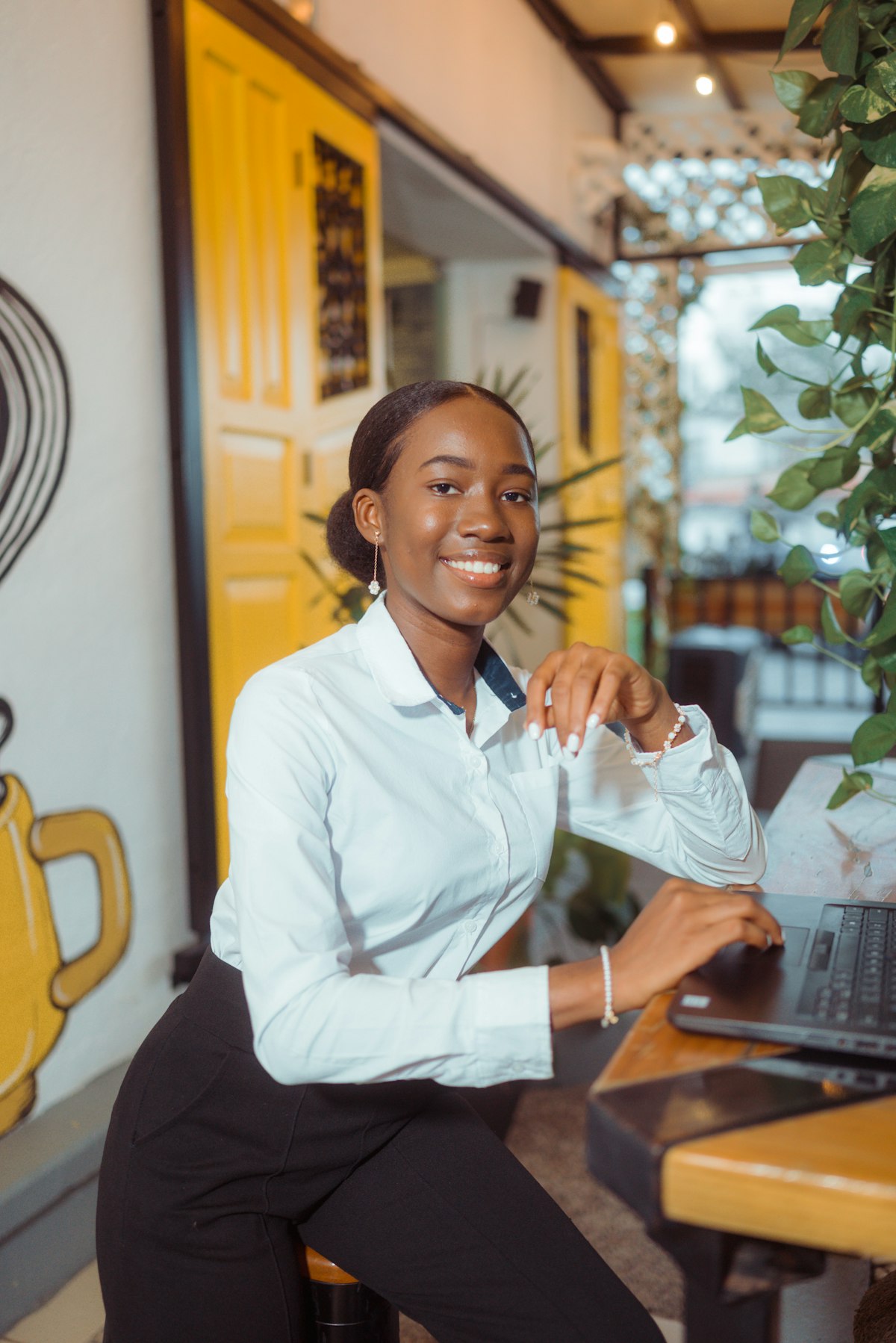 A support professional smiling while working at a laptop