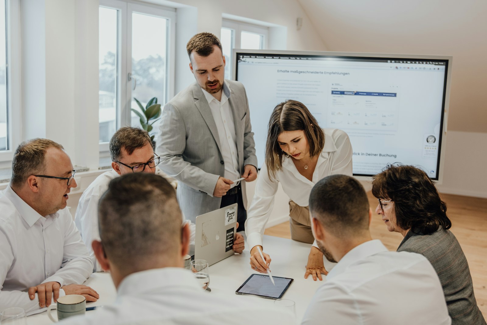 A team planning together around laptops in a bright office